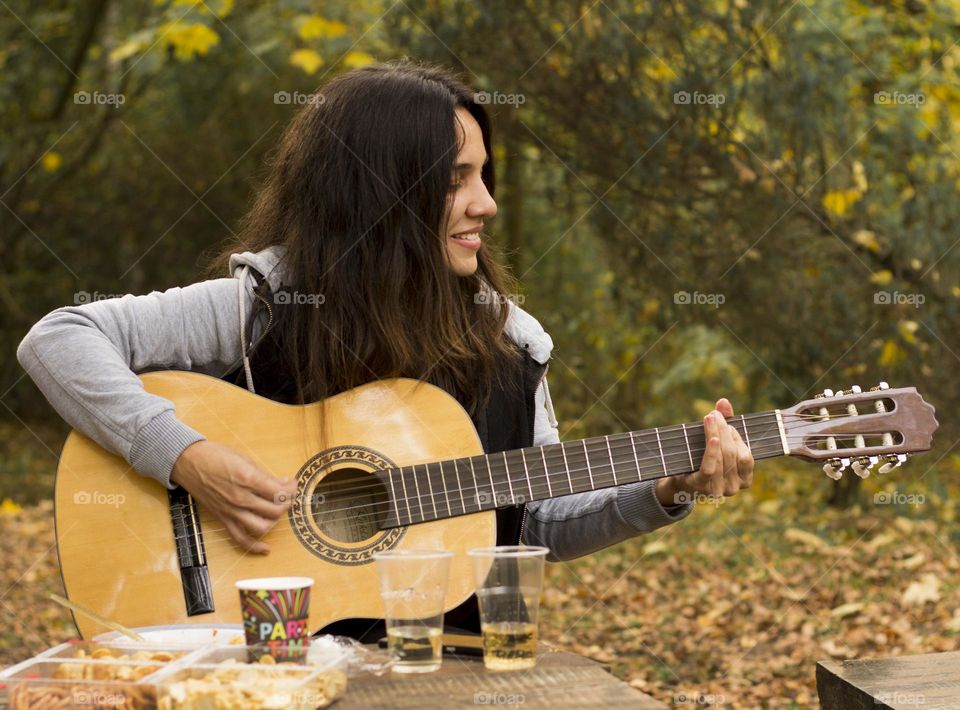 Playing music at the autumn park