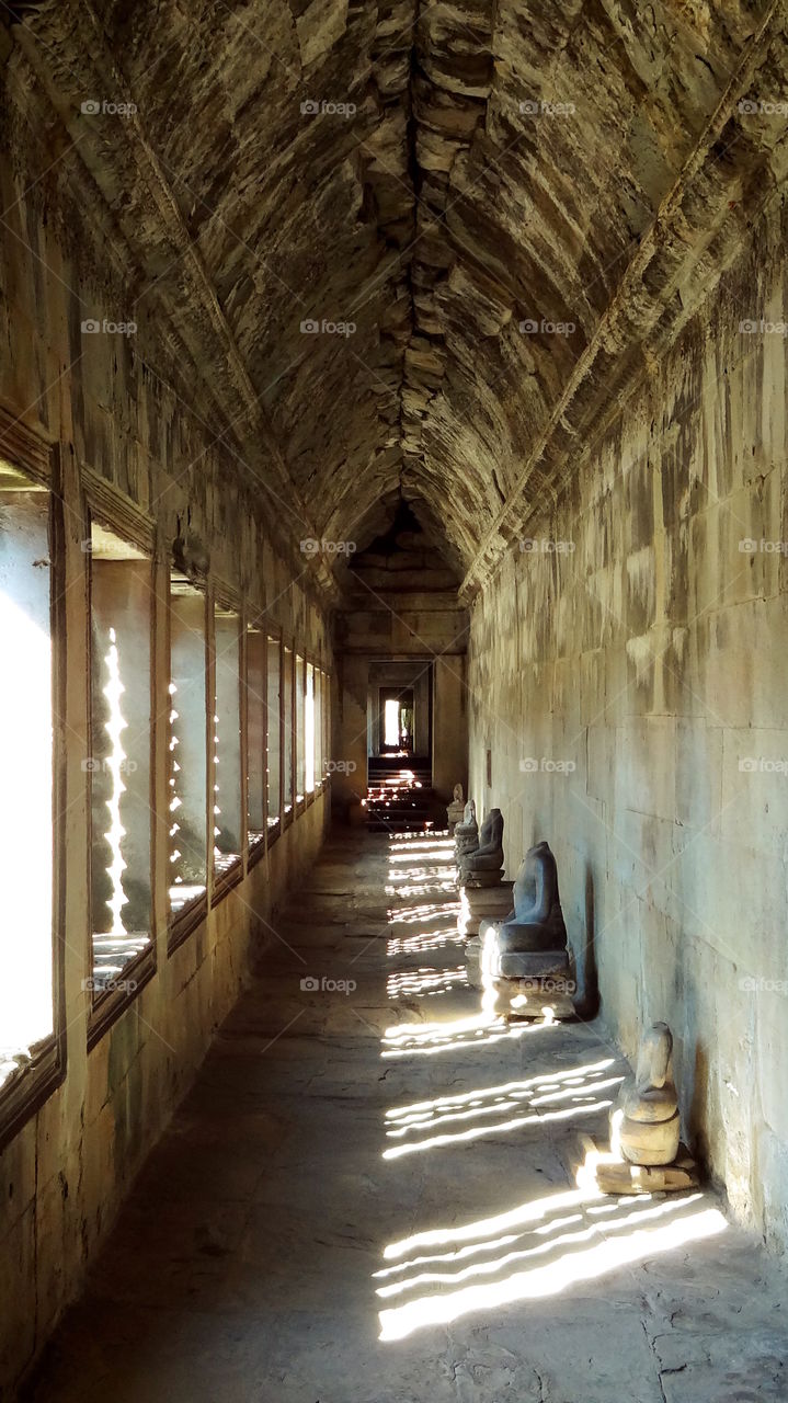 Natural sunlight through open windows. Hallway perspective buddhist temple, ankgor wat cambodia