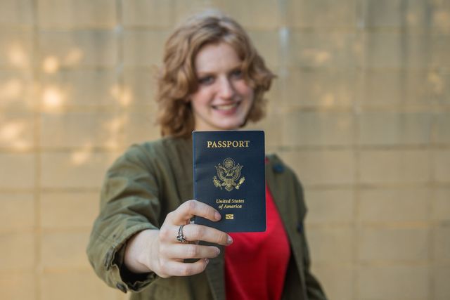 Smiling girl holding USA passport