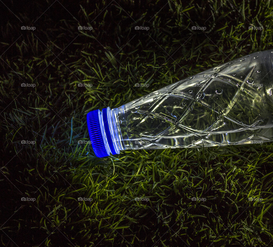 a bottle in the green grass....