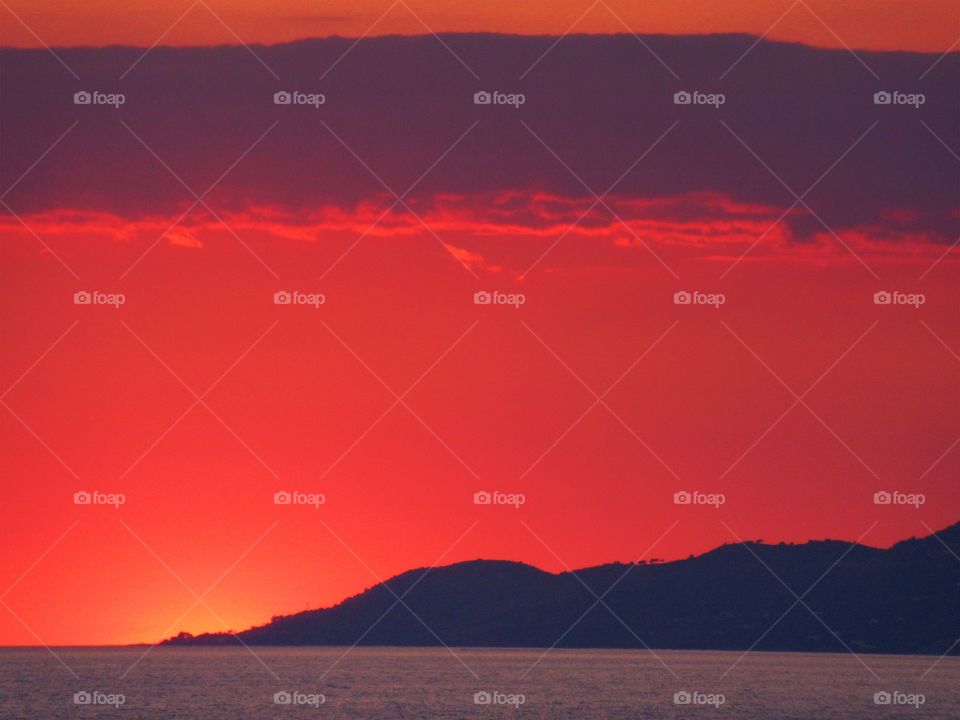 Red clouds in Red Sky over Cape D'Arena  (Italy ).