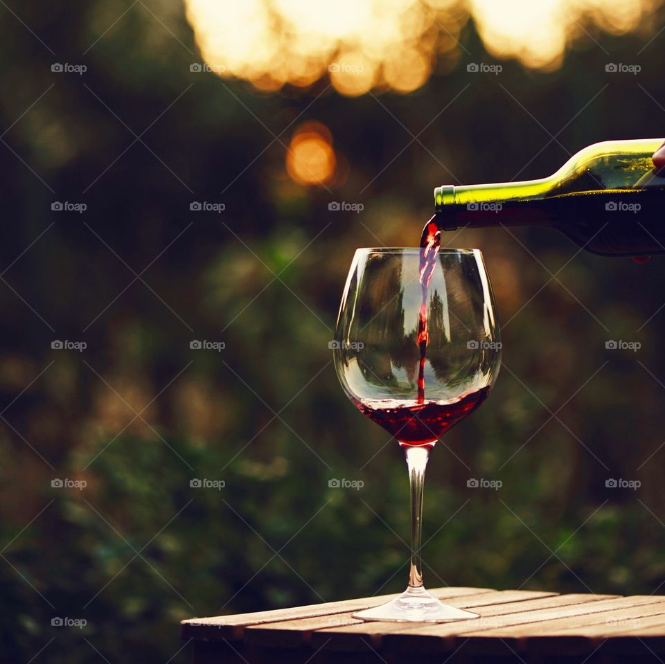 Close-up of wine glass and wine bottle