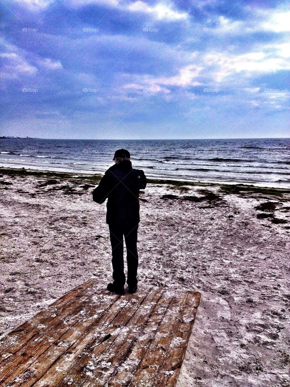 Man from behind overlooking the sea