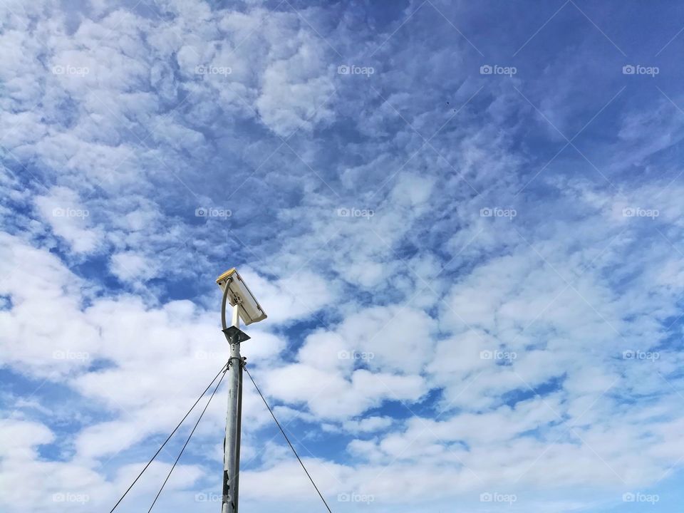 CCTV against cloud and blue sky.