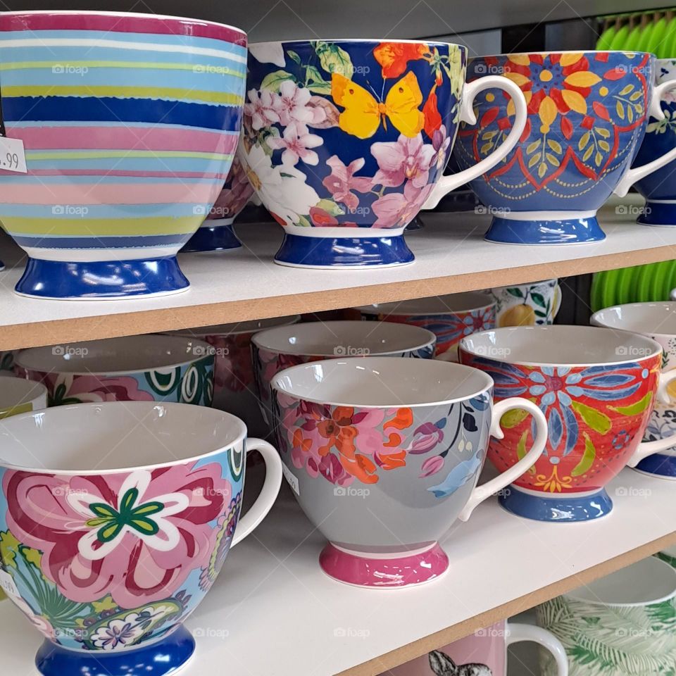 shwlves of colourful mugs in shop