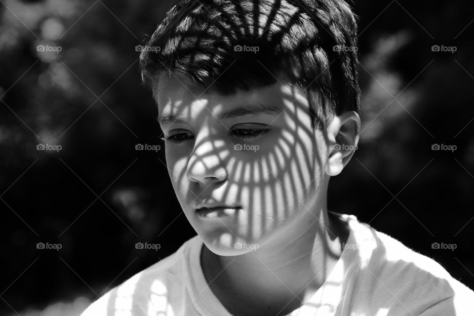 Shadow design on face of boy monochrome