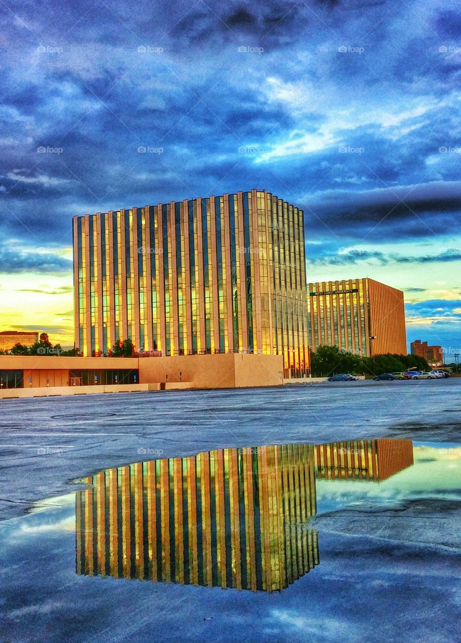 View of building reflection on puddle