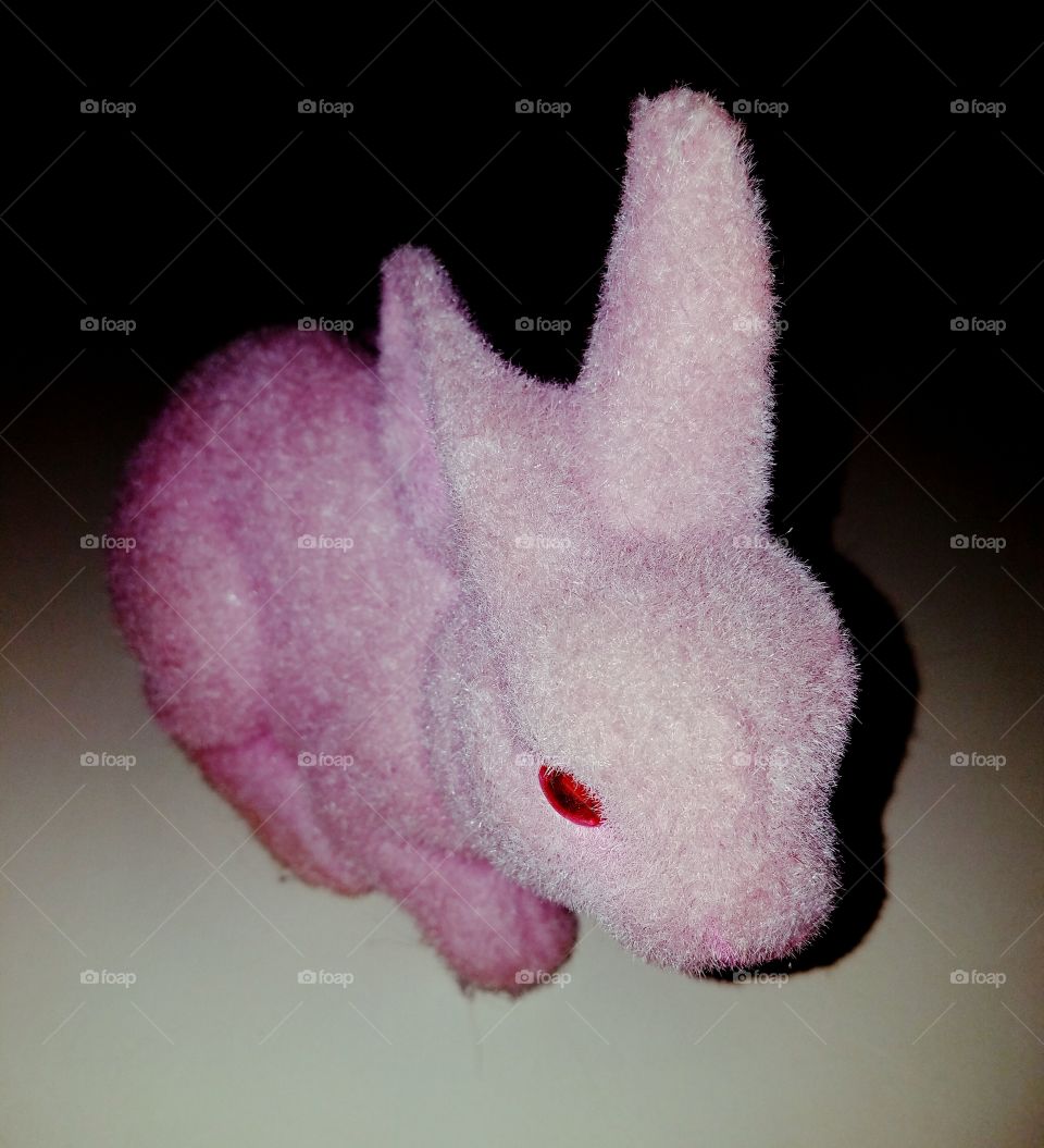 Pink toy bunny, play on pink color.