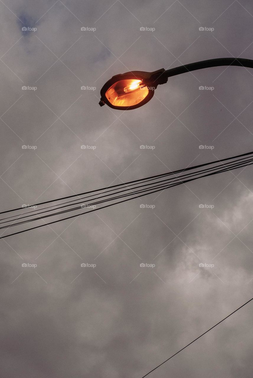 Lamp post with cloudy sky
