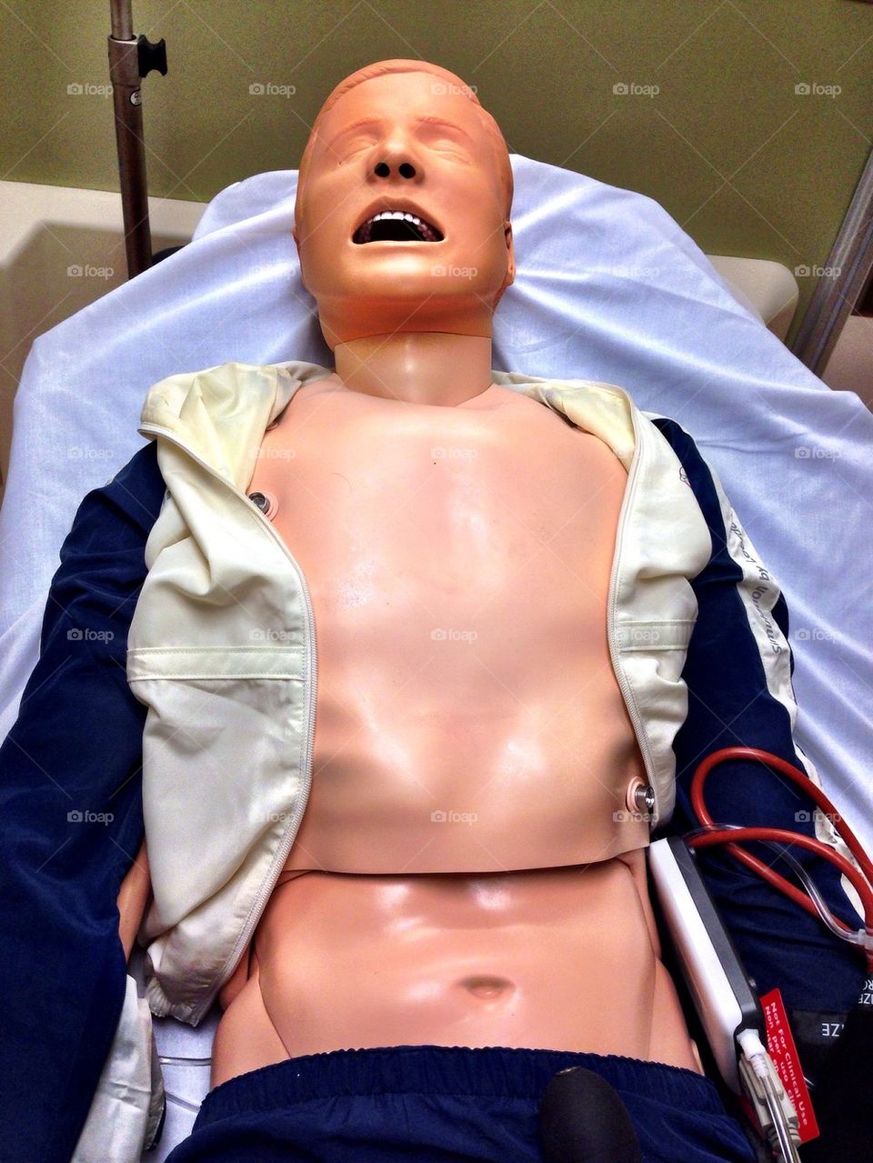 CPR dummy laying on hospital bed