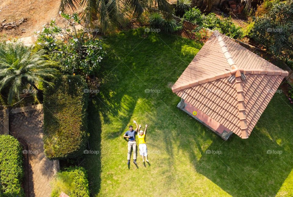 drone shot of friends lying on the green grass ij sunlight 😊