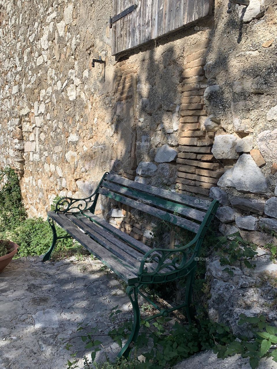 An old broken bench in an unexpected place in a mountain village