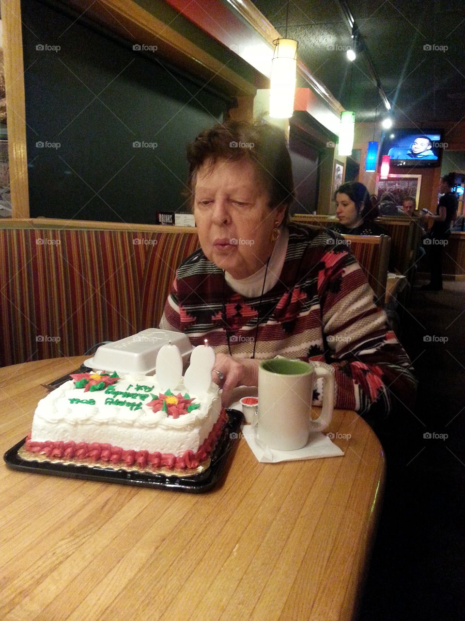senior blowing out candles