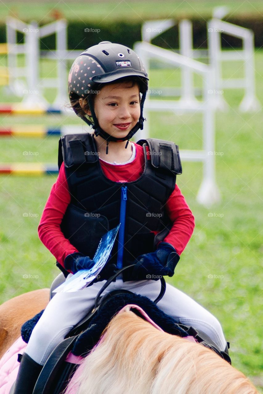 A little girl on racehorse