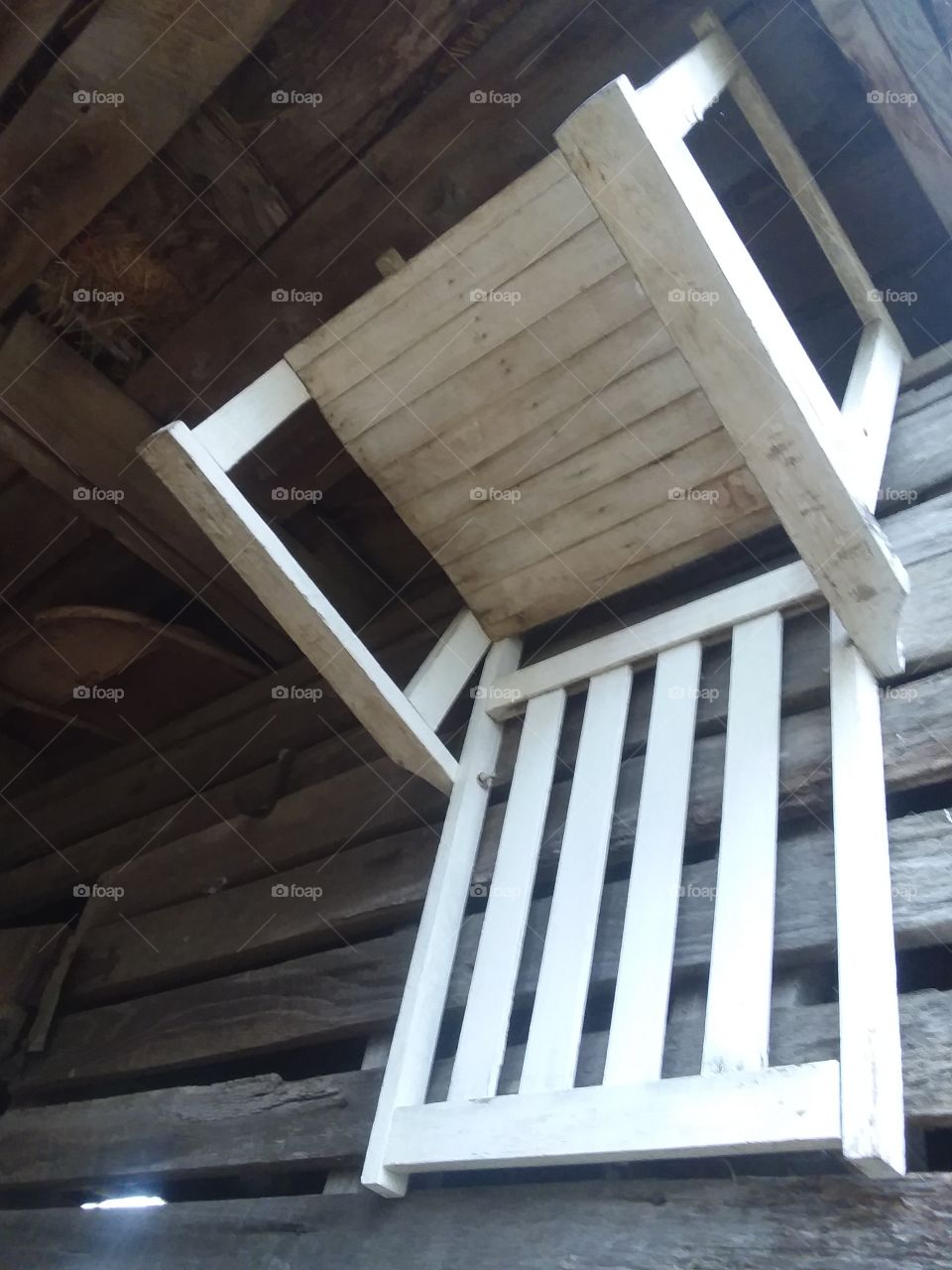 Upside down hanging wooden white chair
