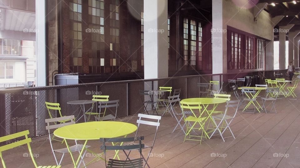 Neon Green Tables and Chairs in a Building Filled with Beautiful Windows