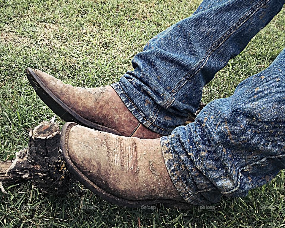Muddy boots and jeans after a hard day of pasture work. 