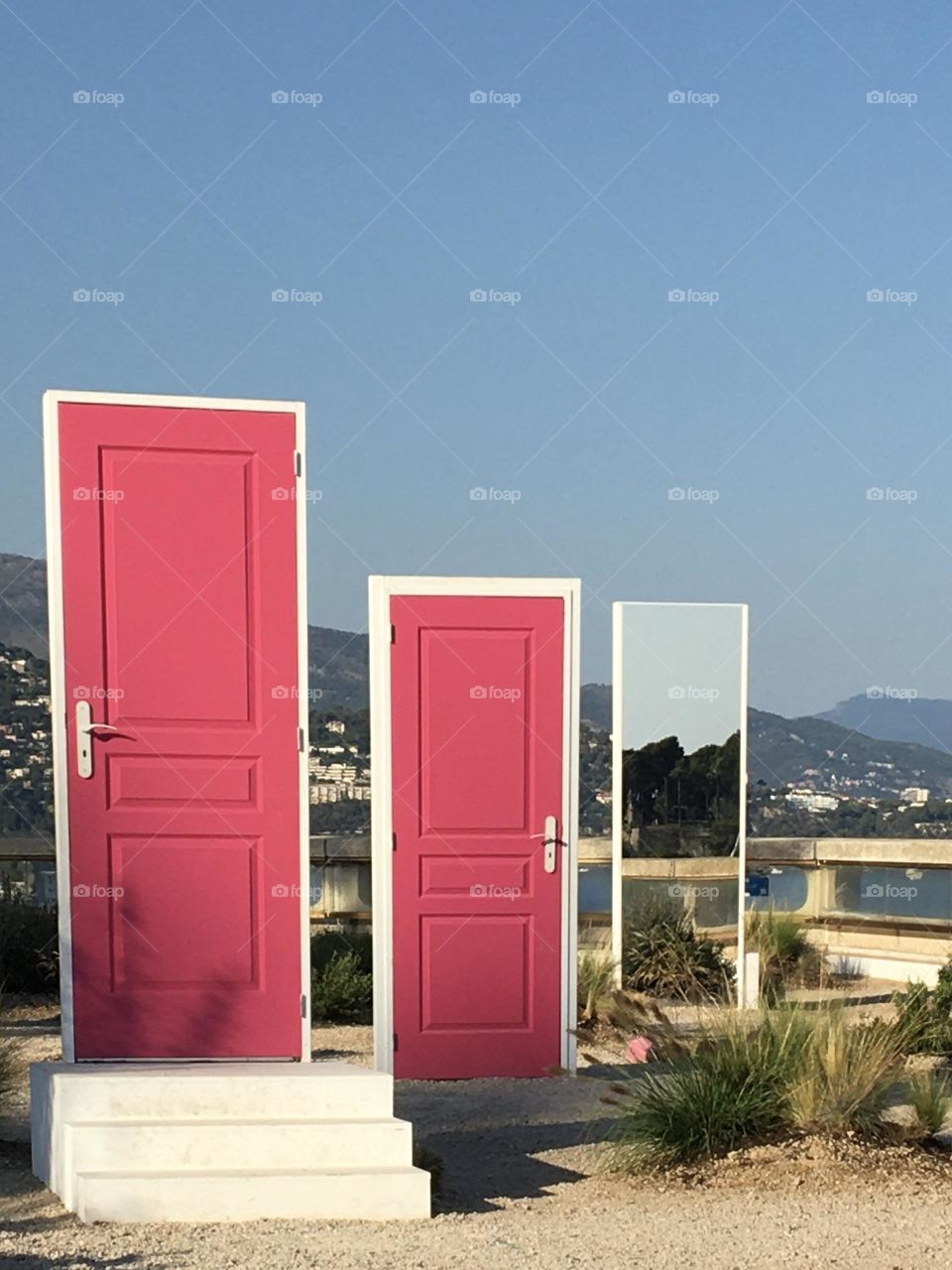 Magenta doors opening on landscape 