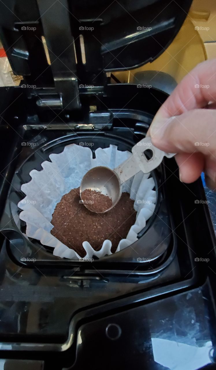 Making a pot of coffee, grounds are put in paper coffee filter. French Vanilla is todays choice of flavors☕!