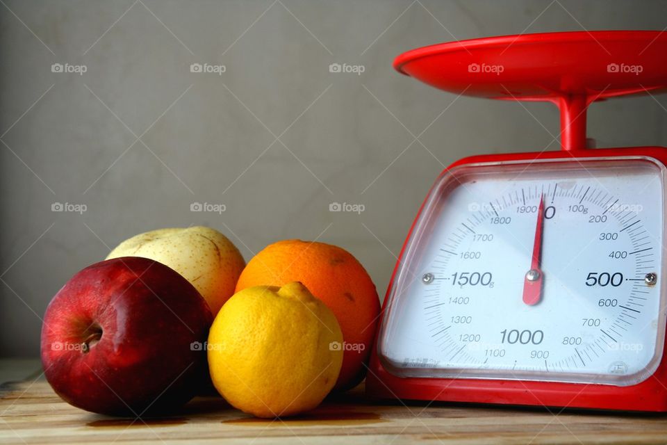 fresh fruits and a weighing scale