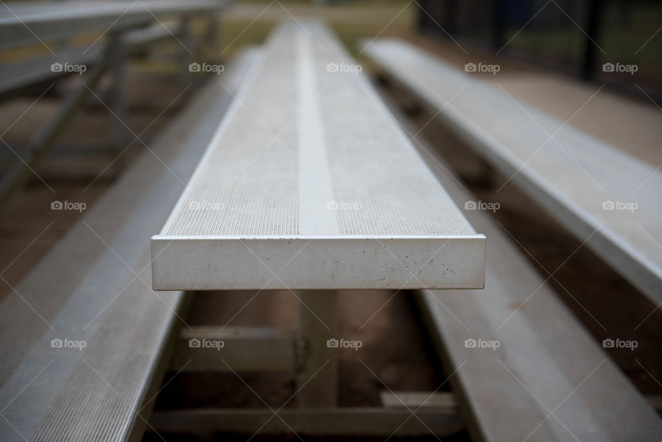 Linear close-up of metal bleacher seats