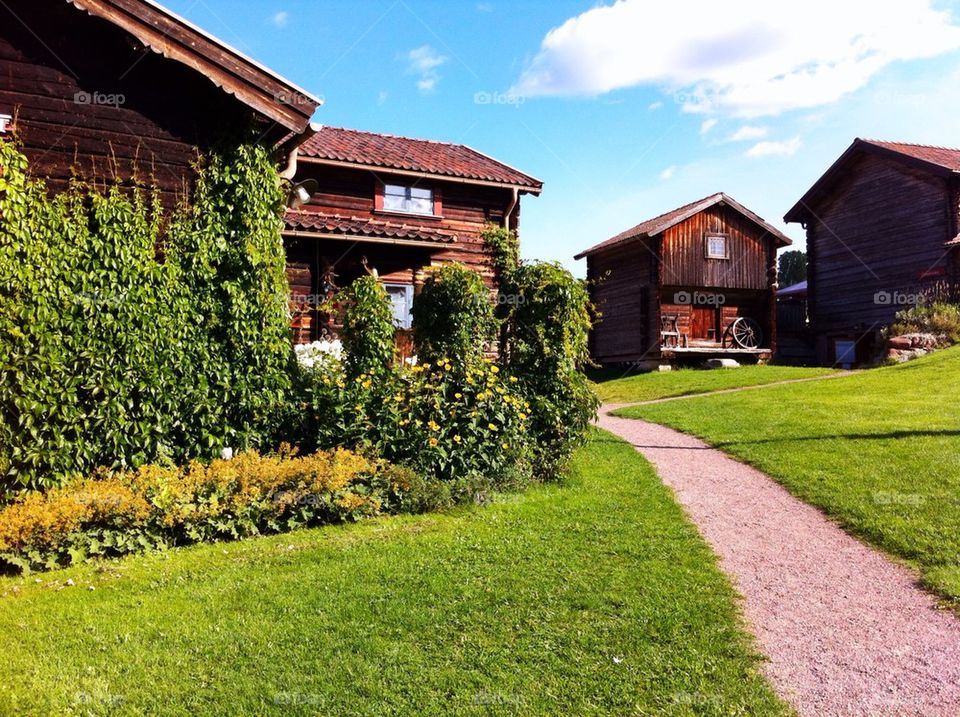 Courtyard with brown timbered buildings in Dalarna.