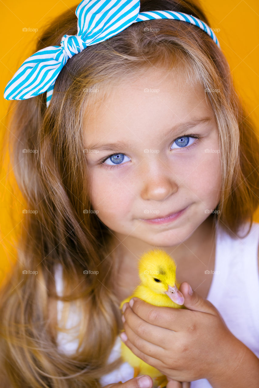 Cute girl with little duck. Summer time 