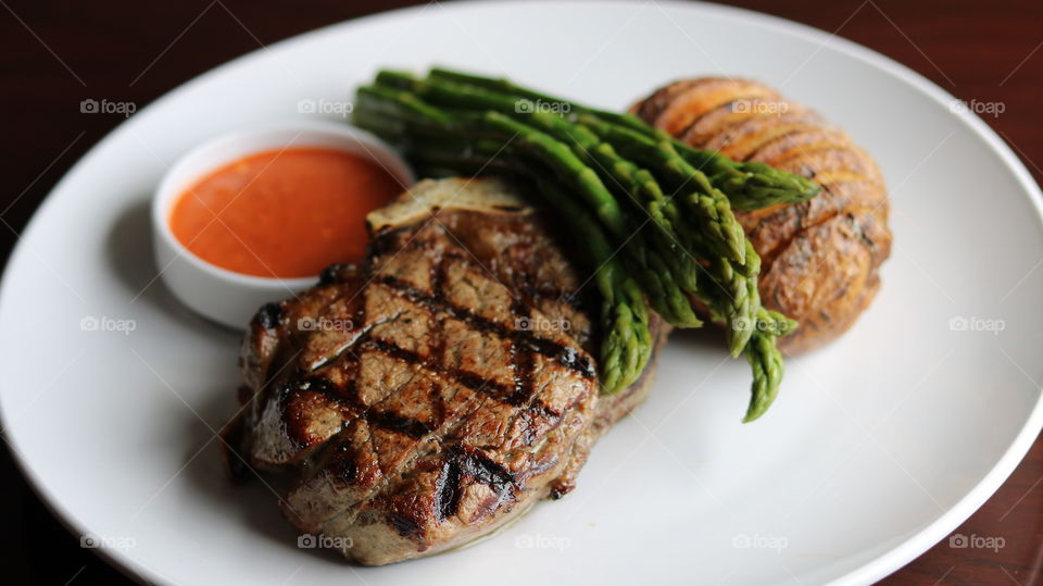 Filet Mignon with Asparagus, Hasselback Potato, & Piri-Piri sauce 