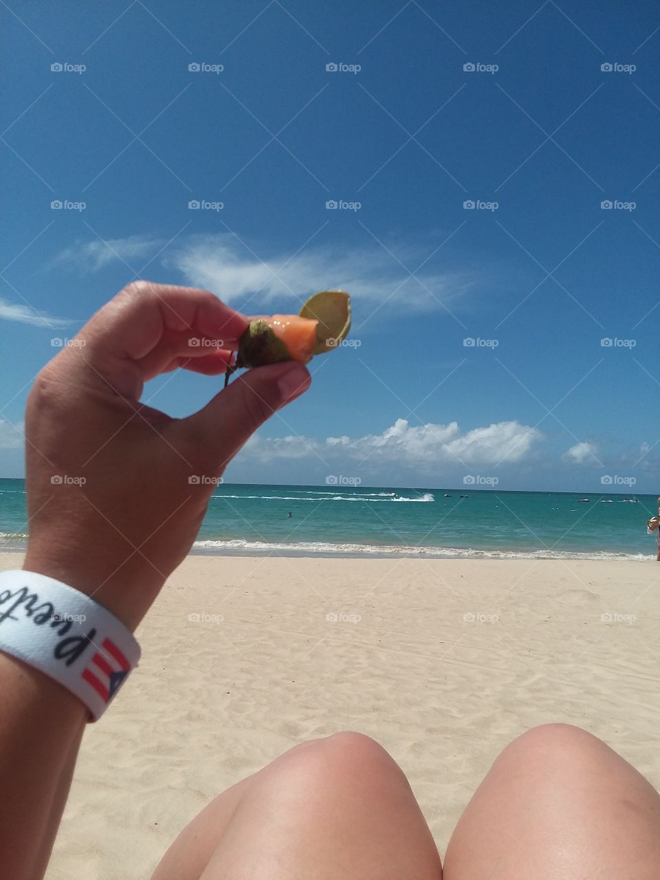 Relaxing eating a quenepa treat in Puerto Rico beach
