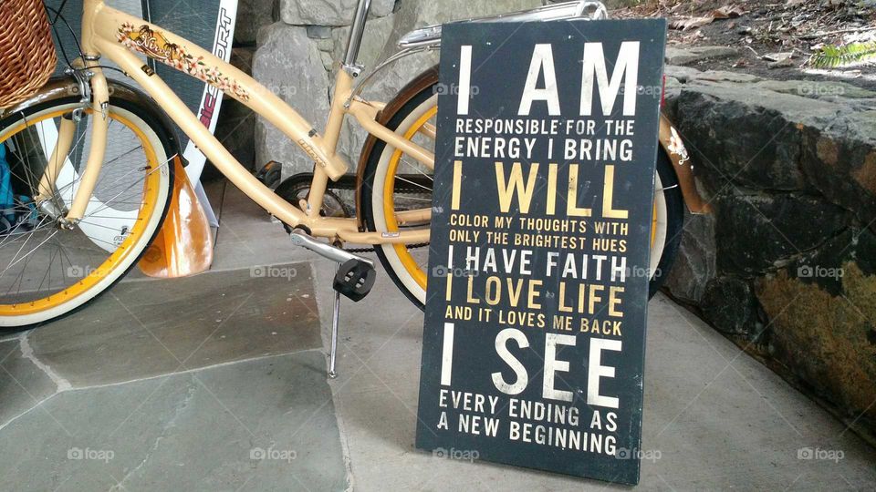 Inspirational sign next to vintage bicycle