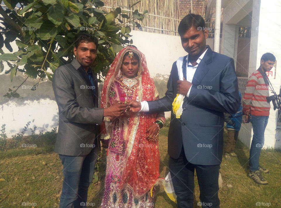 Indian bride and groom with guest