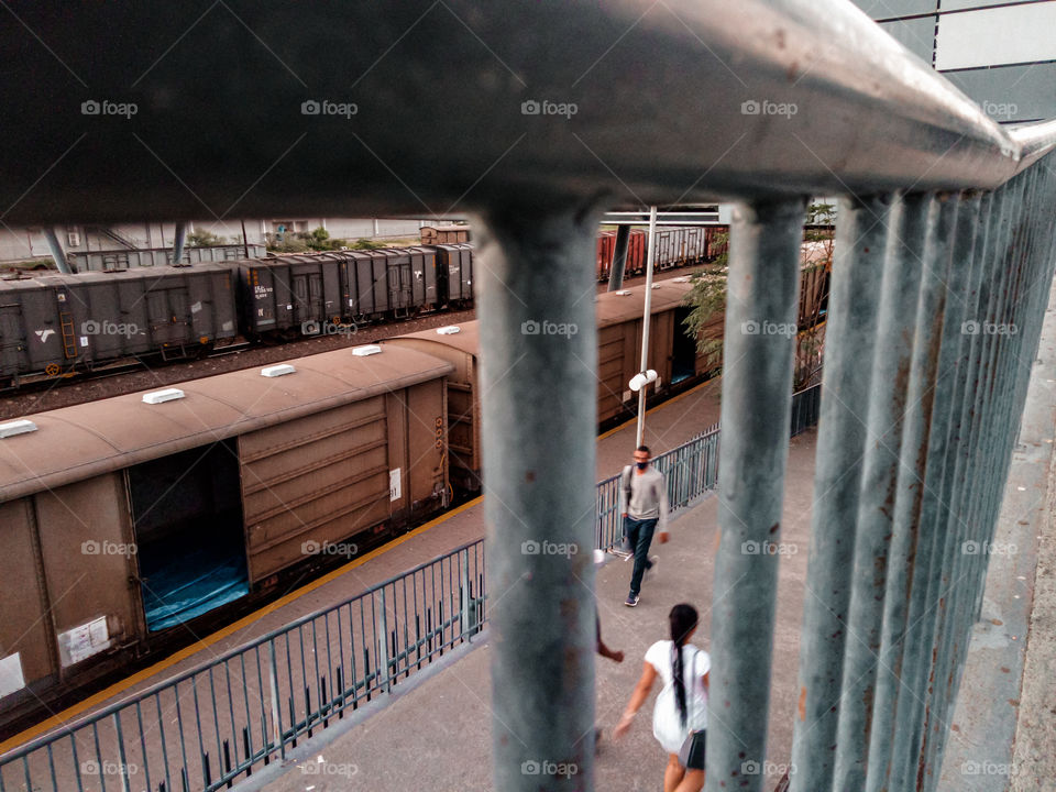 Train station walkway with people passing up and down