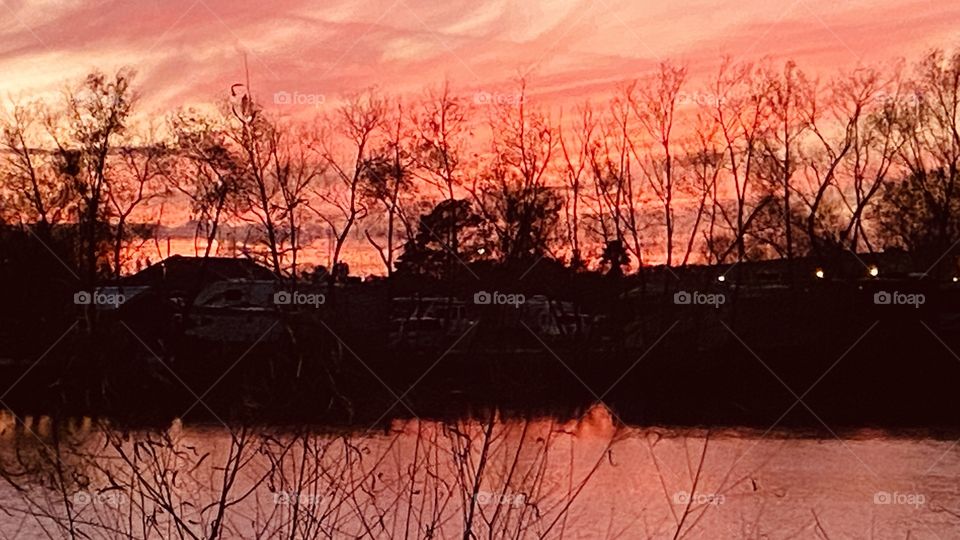 High Clouds adjusting the sky during Sunset. Colors radiating within all the feathering of clouds with wind patterns. More Vivid Colors showing the Twilight fade of Sunset.