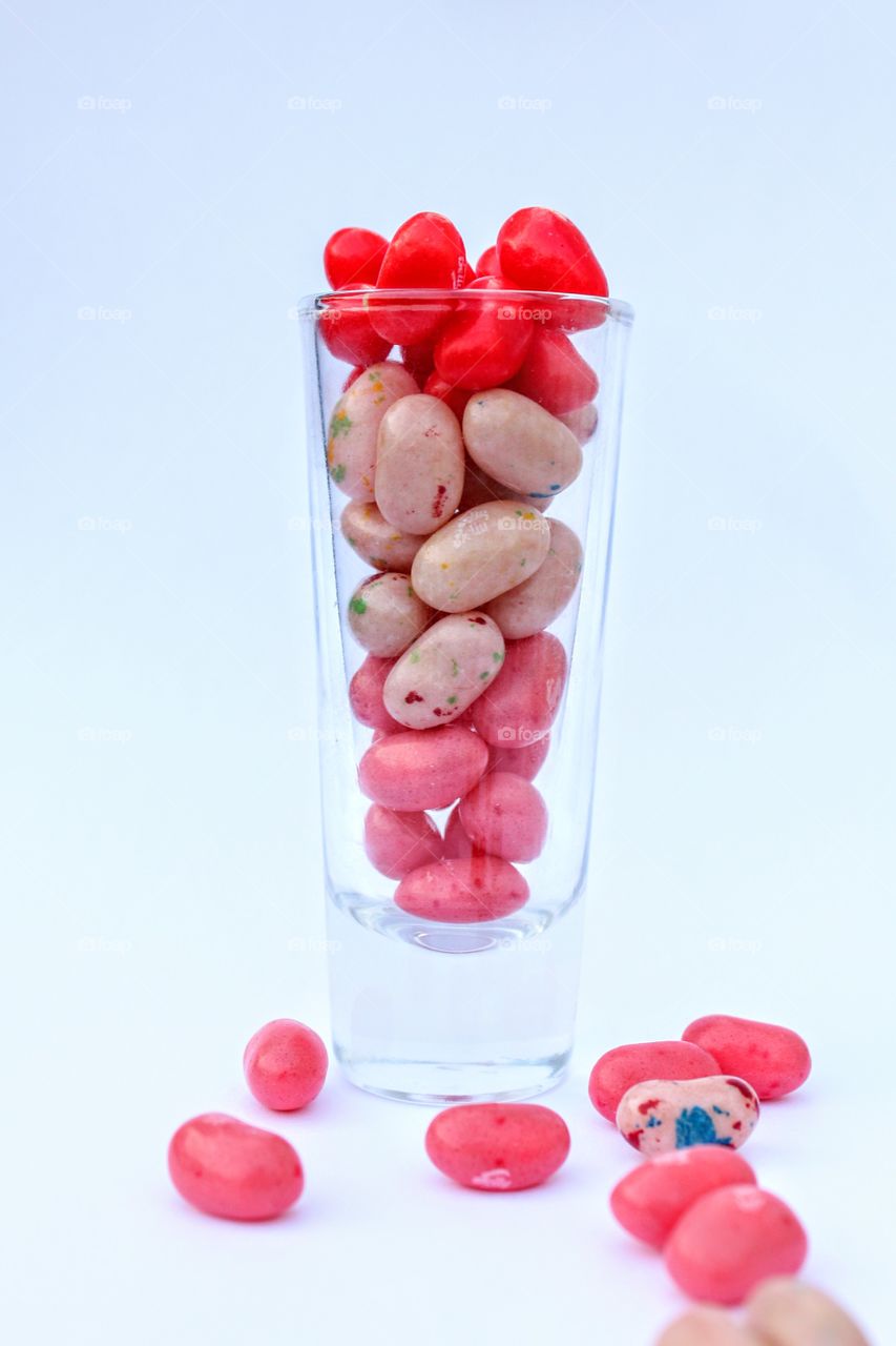 Jelly Belly jelly beans in a shot glass against a white background