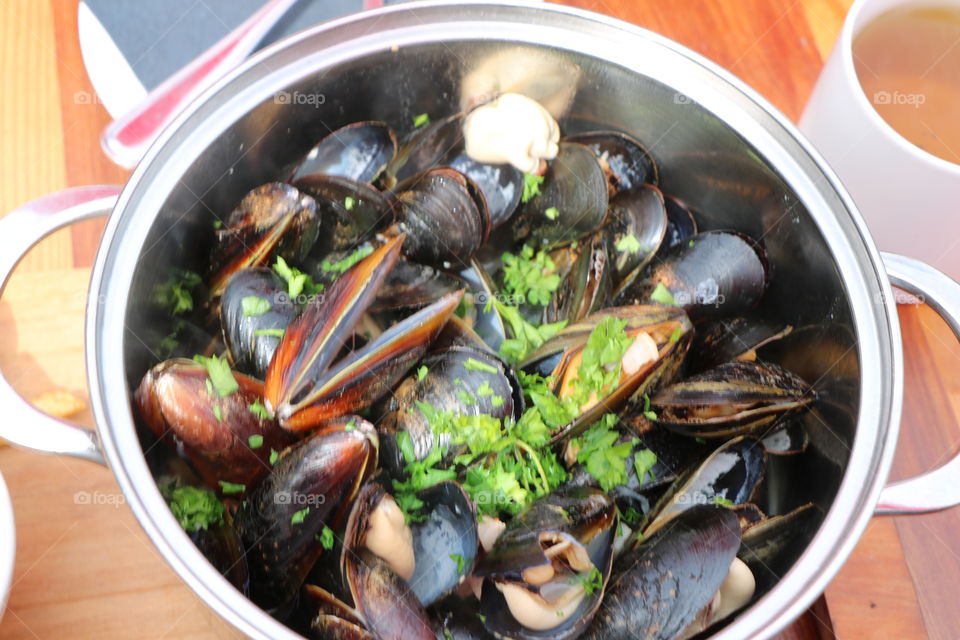 Mussels in a broth with garlic wine and herbs- delicious 