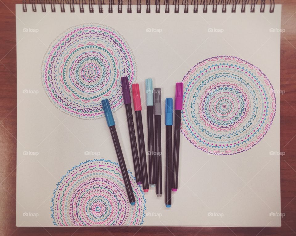 Colorful Markers with Artistic Pattern Doodles in a Sketchbook