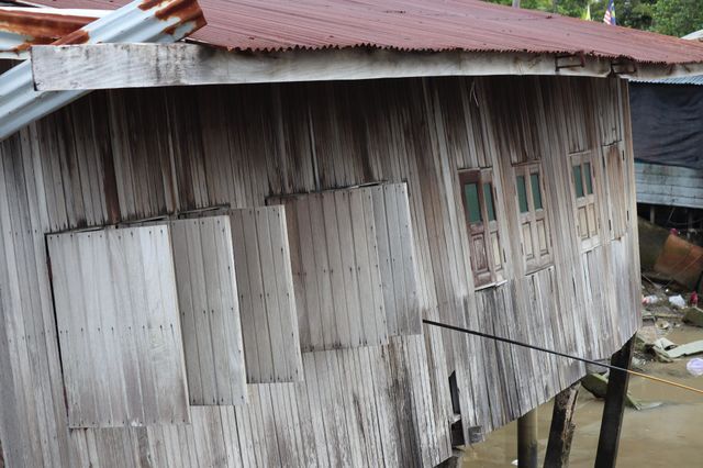 An old tilted house on a riverside. Vintage looks
