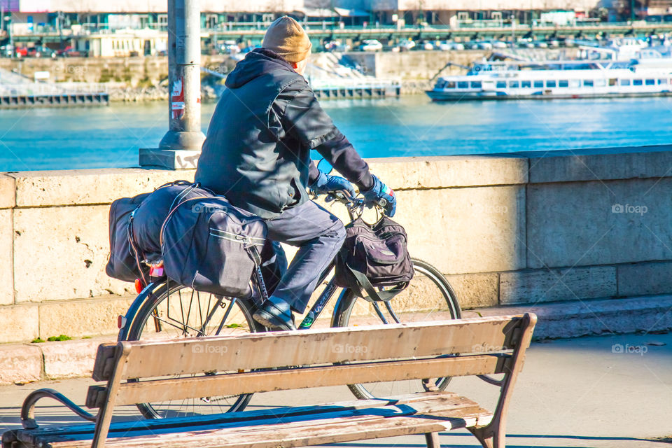 Senior Man With His Baggage Riding His Bicycle In The City
