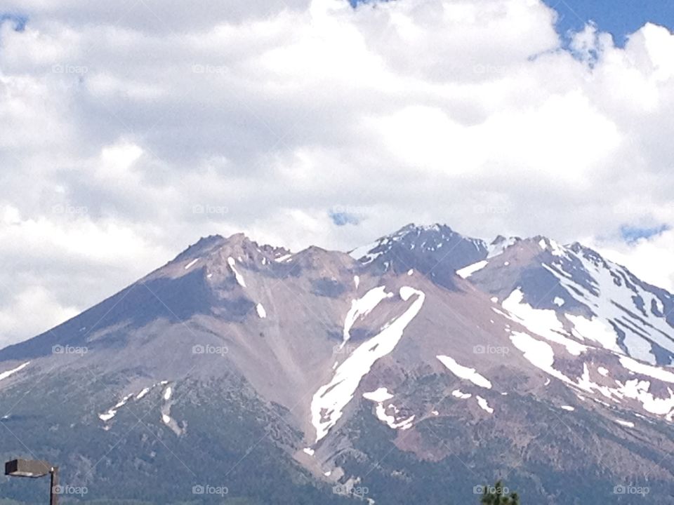 Summer Snows. A view of Mt.  Shasta in July, on the road from drought-ridden  Weed, California into the Oregon border.