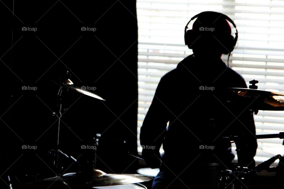 shadow of a drummer during a recording session
