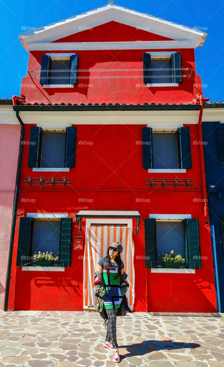 Young woman standing in front of house