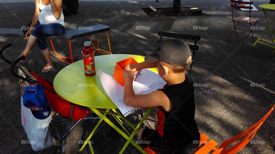 kid painting, boy doing paper work, boy writings, kid activity