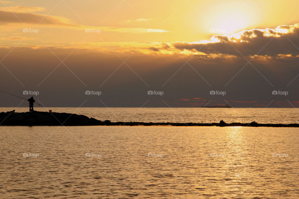the fisherman relax time in the sunset
