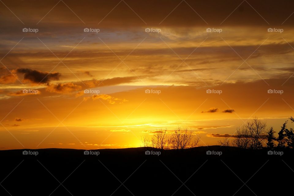 Landscape silhouette with sunset colored sky