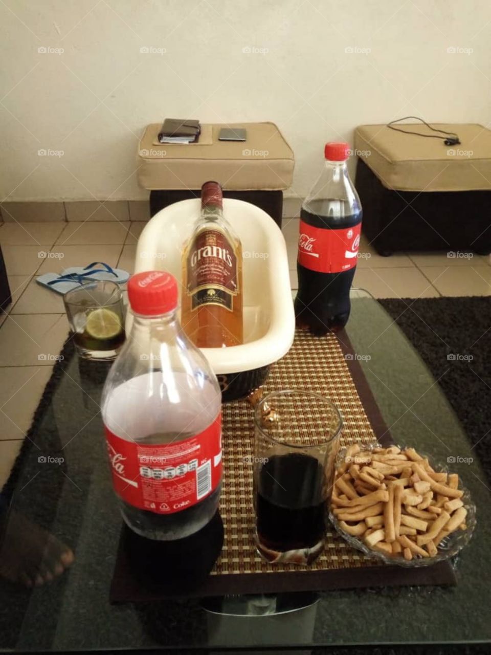 A glass of grants mixed with Coca Cola and lime to spark off the day