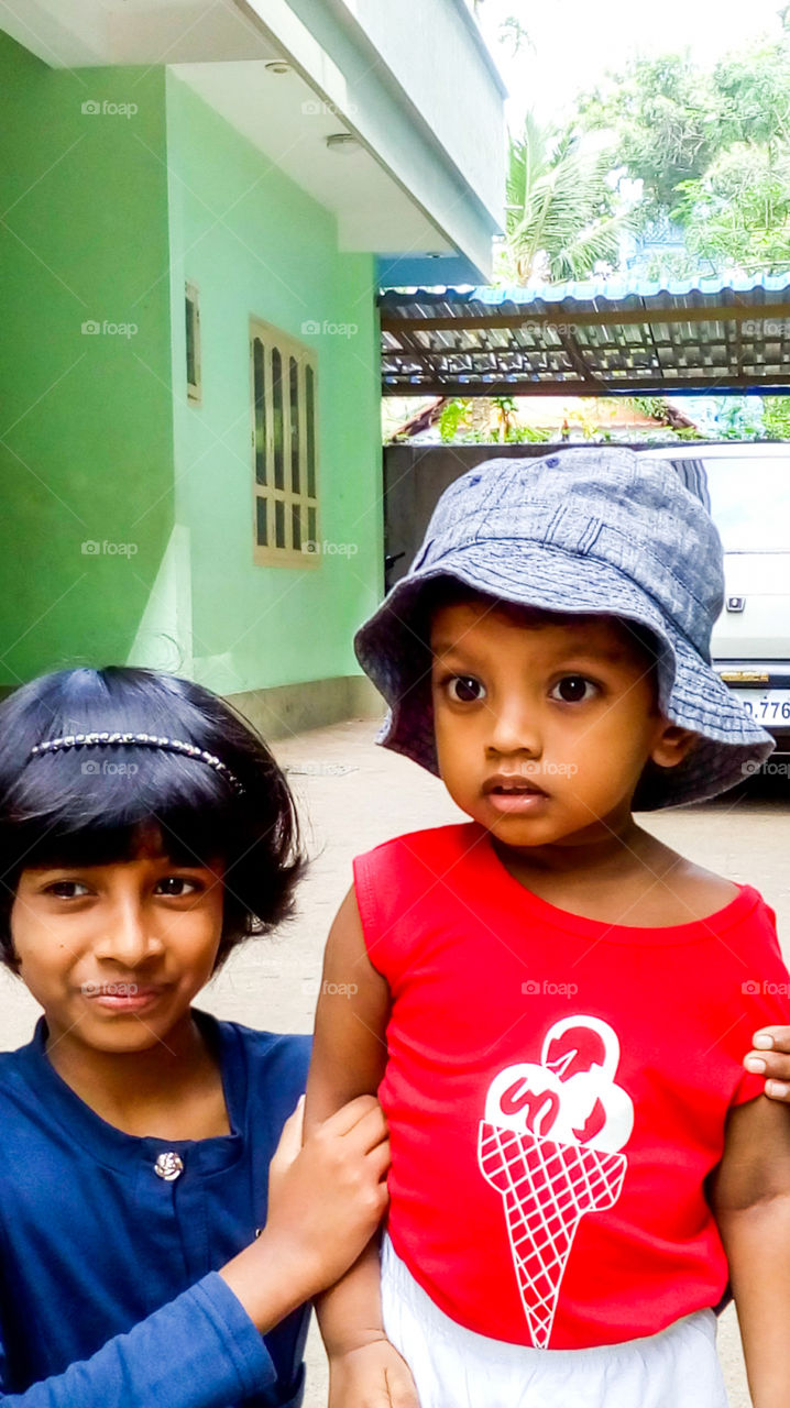 Siblings love - sister holding her brother with love and care