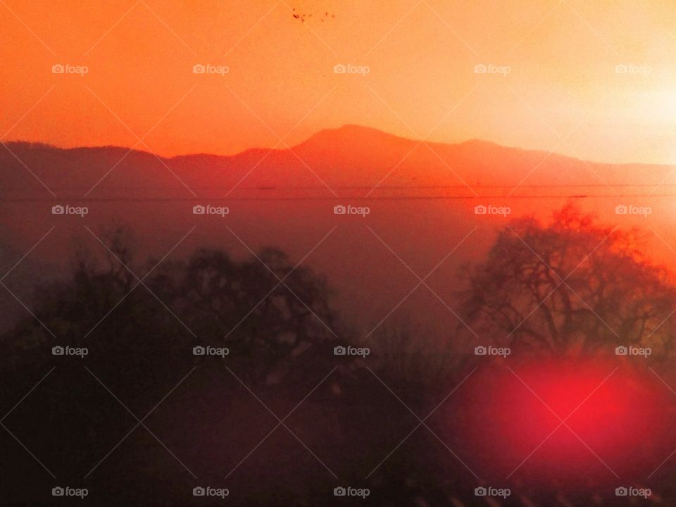 early morning Sunrise as a fog Rose in on the mountain valley.