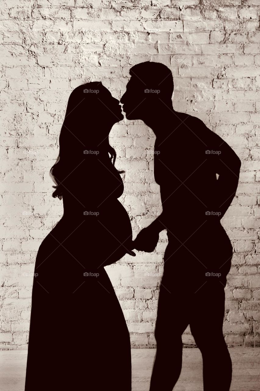 Kissing couple expecting for a baby 