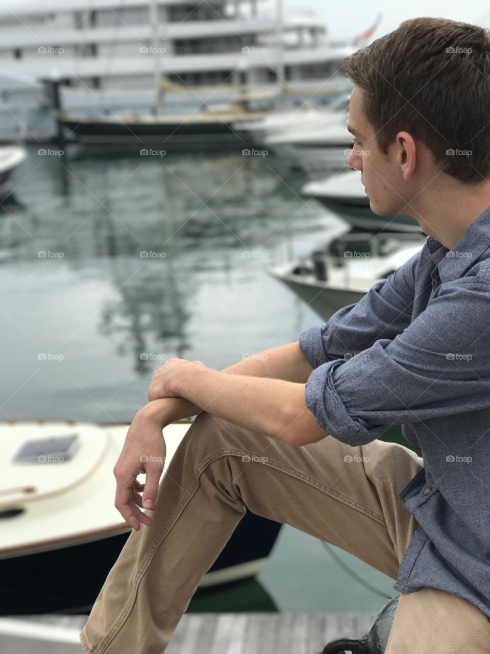 A man looks out onto the harbor 
