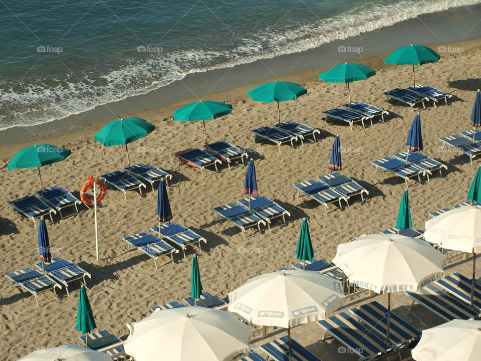 Beach umbrella and lounge chair in the beach